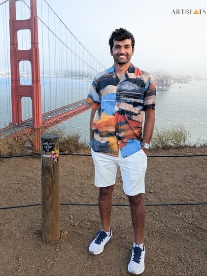 Embracing the abstract and the infinite. A client wears the Infinity hand-painted shirt in front of the Golden Gate Bridge, looking effortlessly bold and timeless.