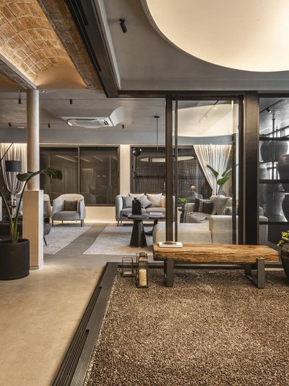 The layout of the showroom is designed to guide customers through different zones, with a mix of open spaces and more intimate settings.