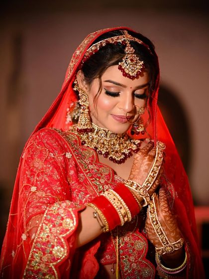 A close-up shot focusing on the bride's flawless makeup and stunning choker necklace.
