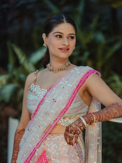A close-up of the bride's carnival look, showing the pastel colors of her outfit and her minimal makeup.