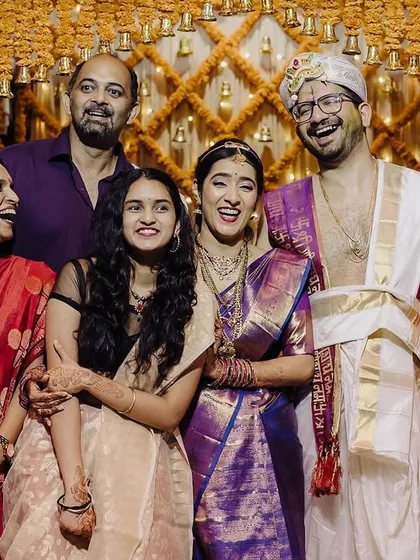 The heart of any wedding is family. I focus on capturing the shared laughter and natural interactions that you'll cherish forever, like this beautiful, candid group portrait filled with happiness against a backdrop of marigolds.