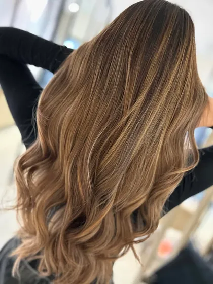 This honey blonde balayage is pure sunshine. The warm, golden tones are blended perfectly from the roots to the ends for a radiant finish.