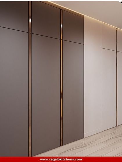 This floor-to-ceiling wardrobe features a two-tone design with sleek metallic inlays, creating a modern and seamless look that blends perfectly with the wall.