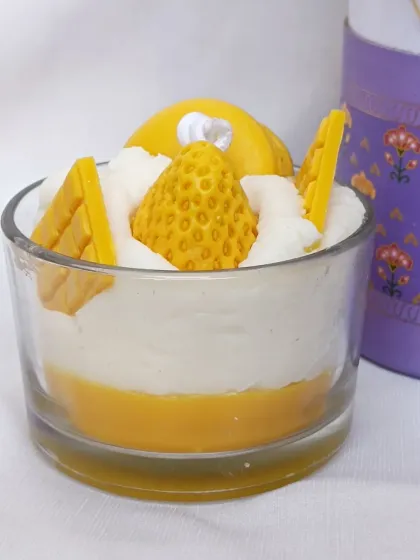 A close-up of my yellow dessert whipped candle, featuring mango, waffle, and macaron wax shapes.