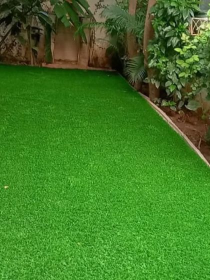 Another view of the backyard turf installation, showing the clean edges and consistent green color.
