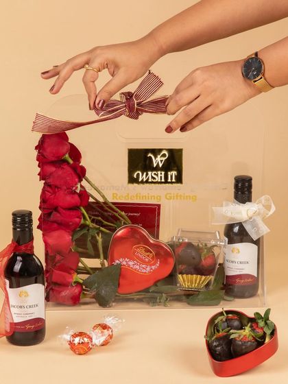 A detailed shot of assembling "The Love Affair" hamper. I love getting the details just right, from the placement of the roses to the final bow.