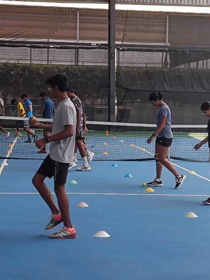A closer look at our players engaged in footwork drills, designed to improve speed and efficiency of movement on the court.