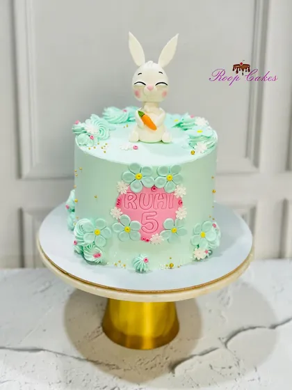 A lovely 5th birthday cake for a bunny lover, featuring a cute fondant bunny holding a carrot.