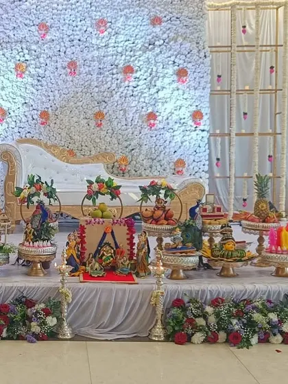 Your gift display should complement your event's decor perfectly. Here is a full stage setup where my decorated platters of fruits, sweets, and themed dolls are arranged to create a complete, beautiful, and cohesive look for the ceremony.