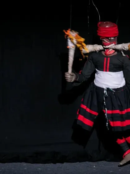Another powerful masked character from the Sri Lankan traditional show, holding torches. The visual spectacle is a key element of these cultural performances.