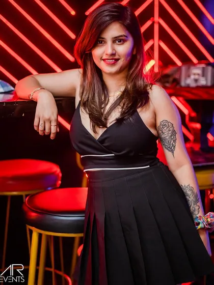A guest with a cool tattoo, posing by the bar.