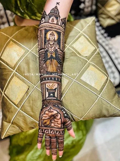 A detailed view of one arm, featuring the portrait of Lord Vitthal inside a temple motif. Below the portrait are other symbolic elements like a tulsi vrindavan and a veena.