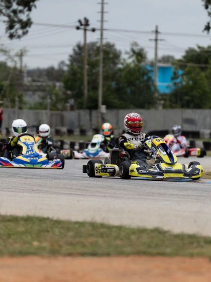 A pack of karts heading into a corner during a heated race at the RMC.
