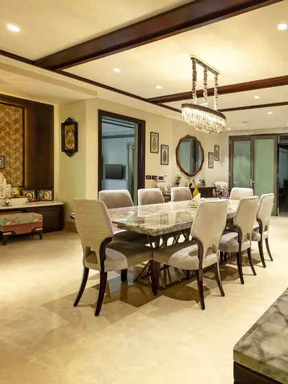 We blur the lines between different zones by using consistent materials and design language. This dining area reflects the home's overall architecture, blending contrasting materials to forge a unified environment.