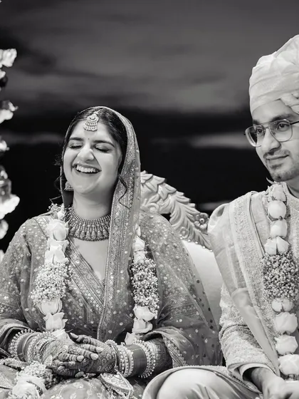 Another angle of the bride's happy laughter, with the groom looking on with a gentle smile. These are the unposed moments that hold the most meaning.
