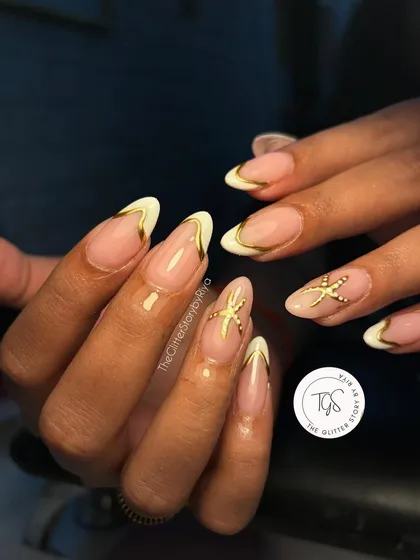 A beach-themed French manicure with a twist. This set features white and gold chrome tips, with a 3D starfish accent for a perfect vacation vibe.