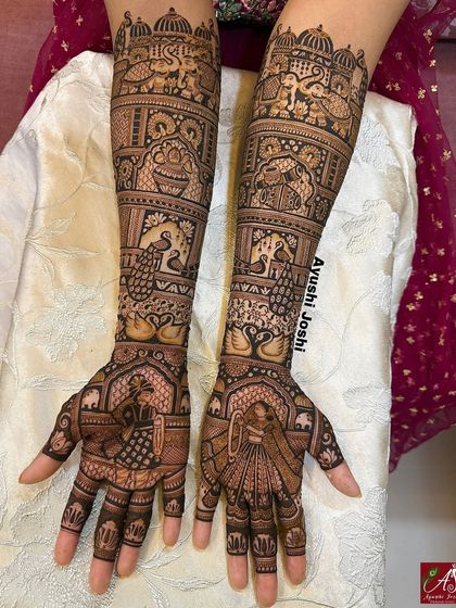 Grandeur in every detail. This bridal mehendi showcases the Varmala ceremony, surrounded by majestic elephants, graceful peacocks, swans, and royal palace windows.