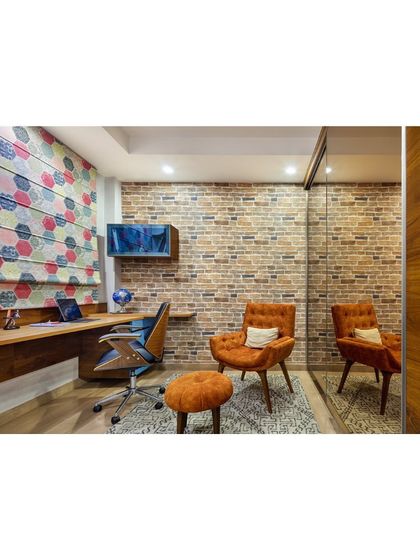 This workstation in the Rue 32 den showcases how to create a functional and inspiring home office in a small space. The exposed brick, colorful blinds, and comfortable seating create a perfect retreat for work and creativity.