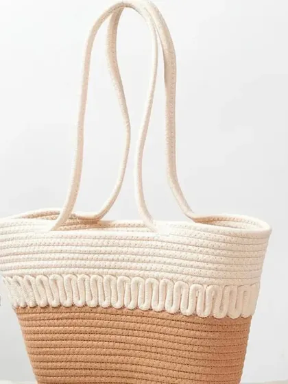 This two-toned jute rope basket bag is a perfect example of aesthetic and multi-use design. It's great as a lunch basket or a stylish tote.