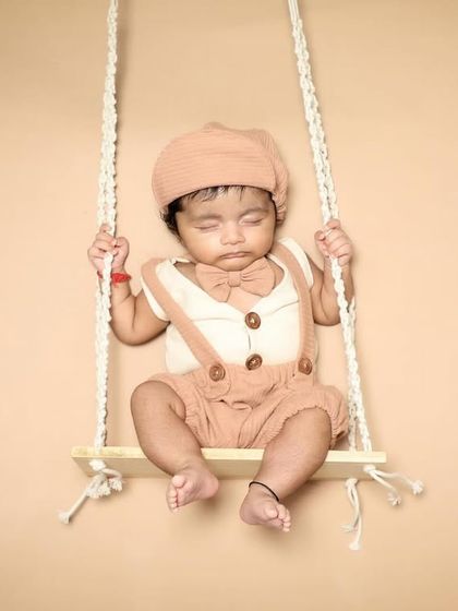 This little gentleman is dressed up and snoozing on a swing. I love styling babies in cute outfits that match the theme of the photoshoot.
