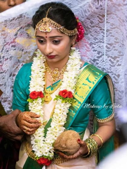 A bride participating in wedding rituals. Her makeup is designed to be sweat-proof and long-lasting, ensuring she looks flawless throughout the traditional ceremonies.