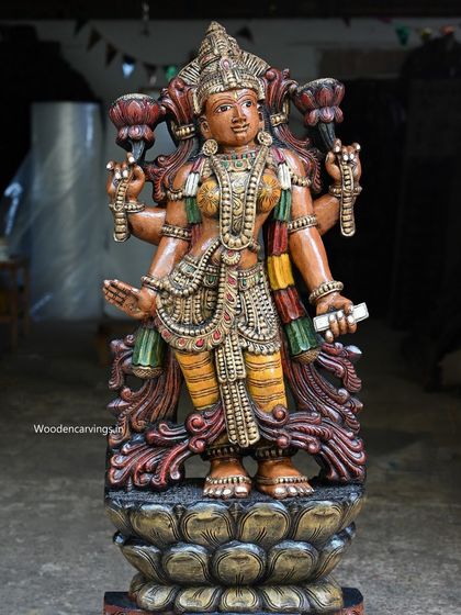 A side view of the 47-inch Lakshmi, showing the depth of the carving and the flow of her garments.