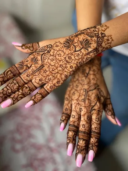 A classic pink and white ombre on long, tapered square nails, shown here beautifully complementing a detailed henna design.