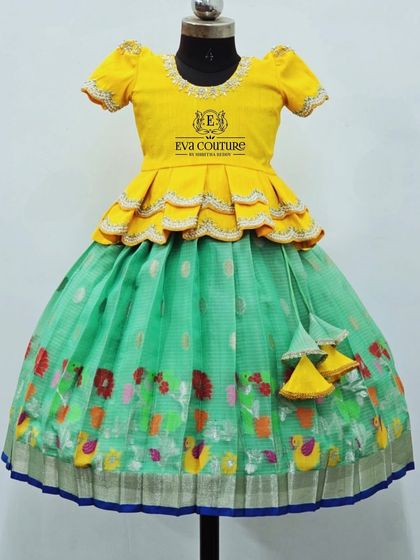 A Zari Kota lehenga with a colorful bird print border. The yellow peplum blouse has scalloped edges.