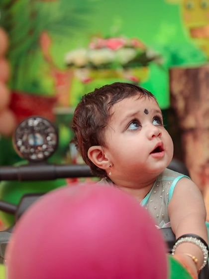 A whimsical 'Butterfly' themed first birthday party, featuring delicate butterfly accents, pastel colors, and floral arrangements, creating an enchanting garden setting.