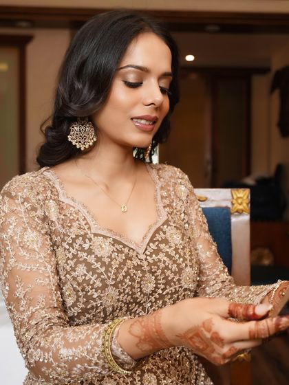 A close-up showing the details of this sophisticated look. The matte base provides a flawless canvas for the bronze shimmer on the eyes and the subtle glow on the cheeks.