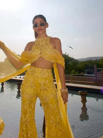 The sunshine-hued sharara in motion, with every shimmer reflecting the light and every detail telling a story of effortless elegance.