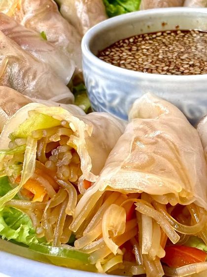 A detailed shot of our Vietnamese rolls, showcasing the fresh ingredients like glass noodles and vegetables packed inside the translucent rice paper.