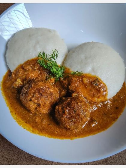 Soft idlis served with my signature Khaima Unde Saaru. The spongy texture of the idlis makes them a perfect vehicle for the rich, spicy lamb meatball gravy.
