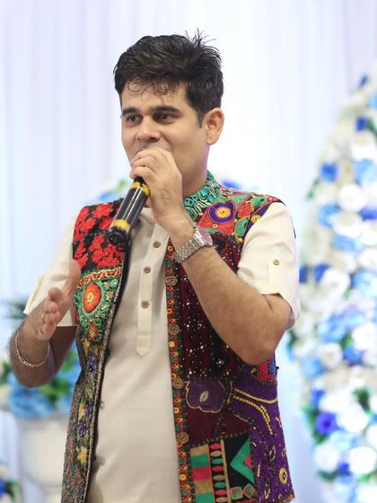 Hosting in front of a beautiful floral backdrop, perfect for a daytime engagement or Mehendi. I always dress to complement the event's theme.