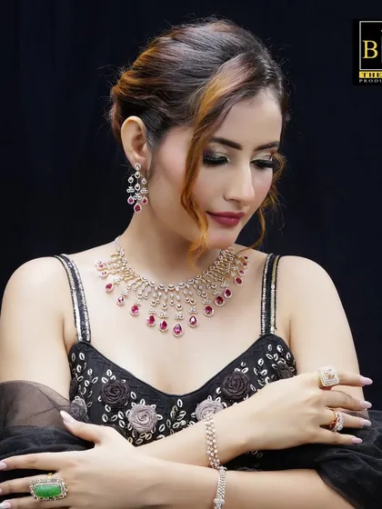 A soft, romantic pose from a commercial jewelry shoot. The elegant updo hairstyle is visible from a different angle, showing its versatility and how it complements the model's features from every side.