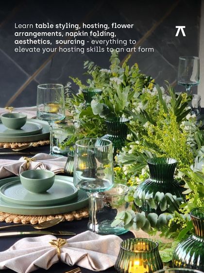 A close-up of a modern table setting with green glassware and carefully folded napkins. Our workshops cover all the fundamentals, from flower arrangements and aesthetics to sourcing, elevating your hosting skills to an art form.