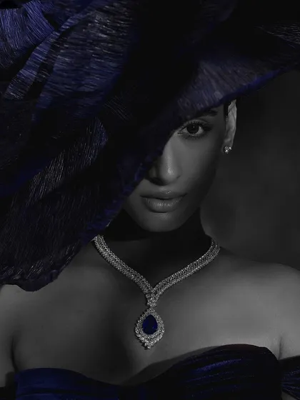 A color-selective black and white image for Purab Paschim, where only the blue sapphire of the necklace is in color, creating a striking focal point.