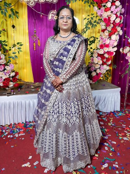 This dark purple lehenga offers a unique and regal alternative to traditional bridal colours. The dense white and gold embroidery creates a stunning contrast, making it a sophisticated choice for a wedding ceremony or a grand reception.