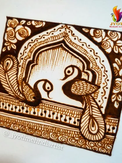 A practice square showing a pair of peacocks within an arched frame, a common element in bridal designs.