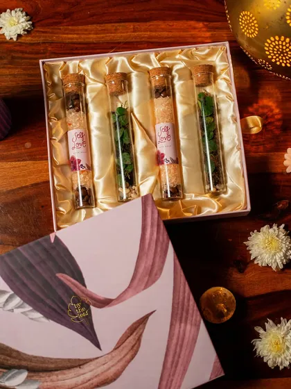 An overhead shot of the Diwali gift box, showcasing the four test tubes filled with mini terrariums and bath salts. This is a thoughtful experience, perfect for gifting or treating yourself.