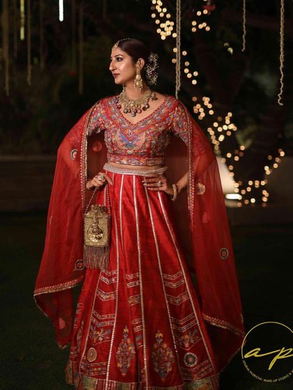 Here I am in a red lehenga at a wedding event. This showcases a full traditional look with coordinated makeup, perfect for a family wedding or reception.