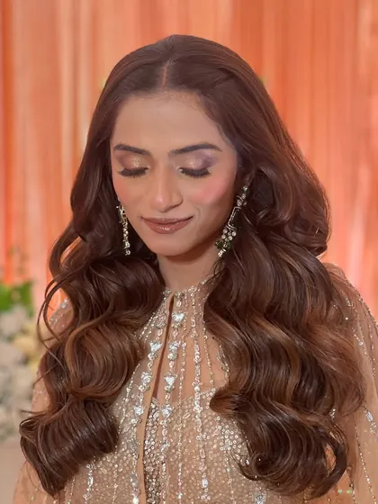 A close-up of the reception hairstyle, showing the soft texture and beautiful shine of the voluminous waves.