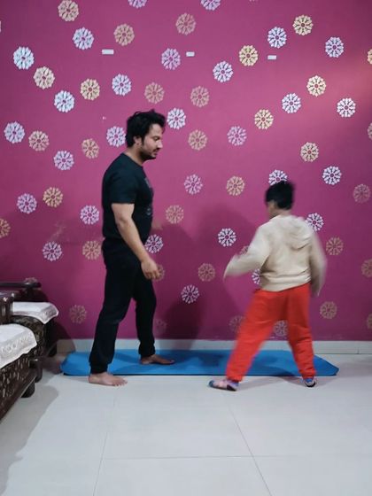 Demonstrating a warrior pose variation to build leg strength and balance.