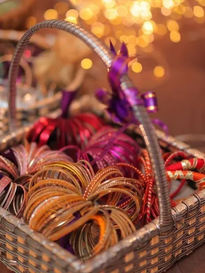 A basket of colorful bangles as favors for guests at a pre-wedding event. It's a wonderful traditional element that adds to the festive spirit of a Haldi or Mehndi ceremony.