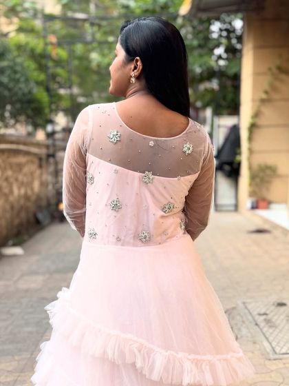 A look at the beautiful sheer back and embroidery detail of the baby pink gown. It’s pretty from every angle.