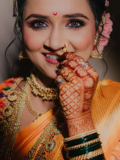 A bright and joyful close-up of the bride, her smile and sparkling eyes capturing the happiness of her wedding day.