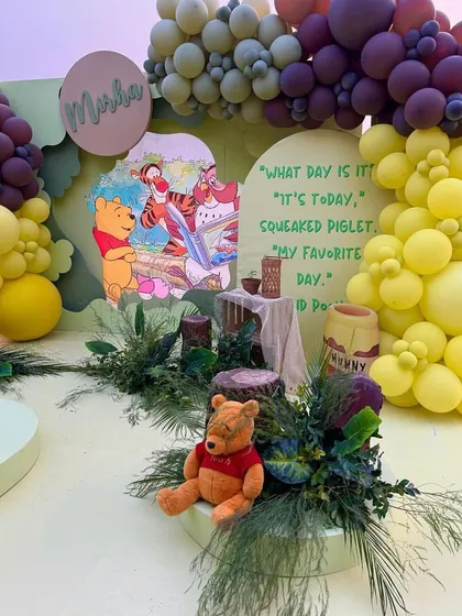 Taking a trip to the Hundred Acre Wood for this Winnie the Pooh party. I designed a charming scene with Pooh bear, a themed backdrop, and natural elements like greenery and wood stumps for an authentic feel.