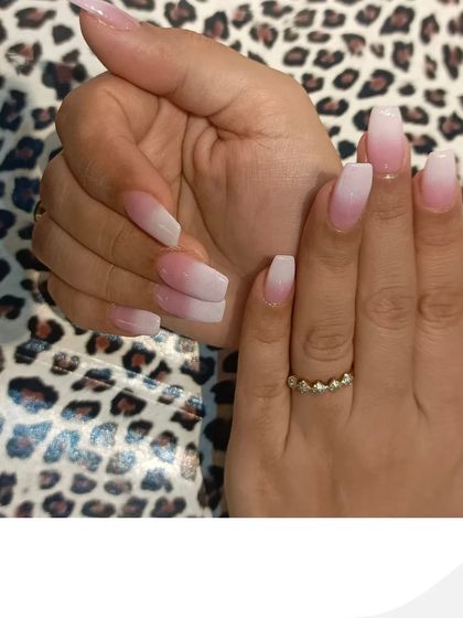 A side view of the ombre nail extensions, highlighting the structure and shape of the nails. This classic design remains one of our most requested services for its sheer elegance.