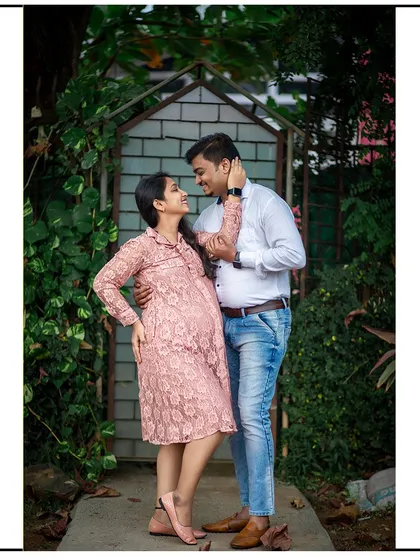 A full-length portrait of the couple sharing a loving gaze, perfectly framed by a rustic garden archway.