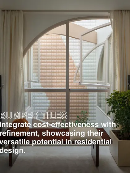 Bumper tiles, typically used for roofing, are repurposed here on a wall, viewed through an arched window. This showcases our innovative use of everyday materials to create refined, cost-effective design features.